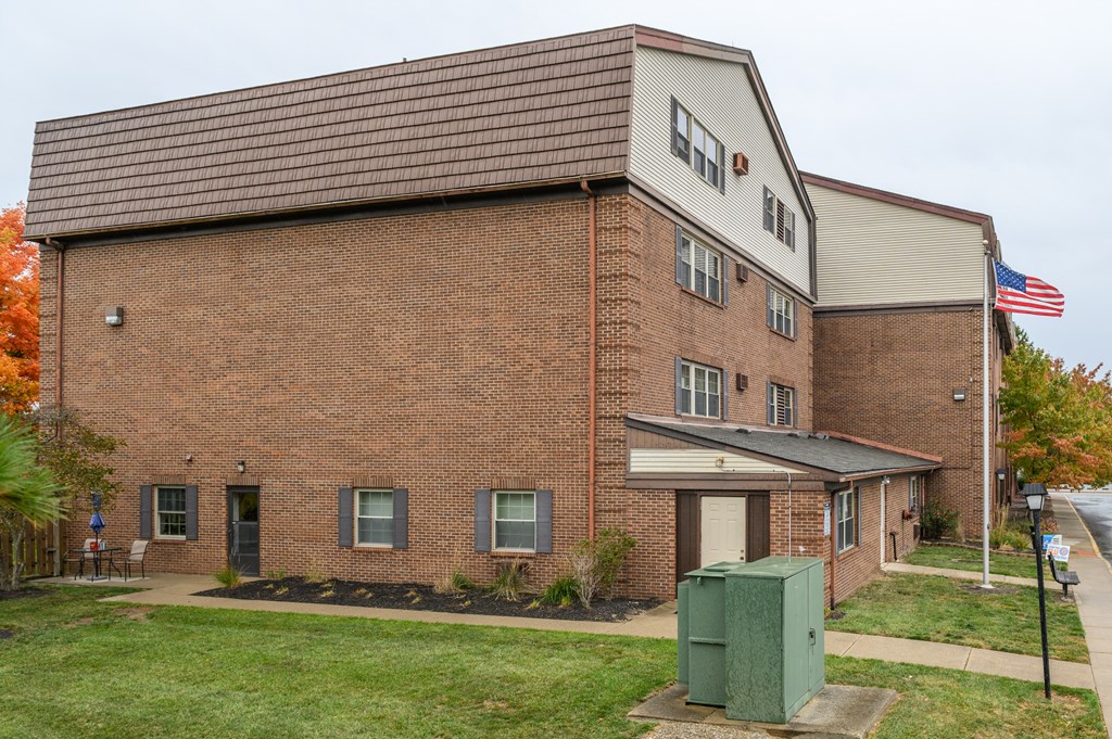 a brick building with an flag in front of it