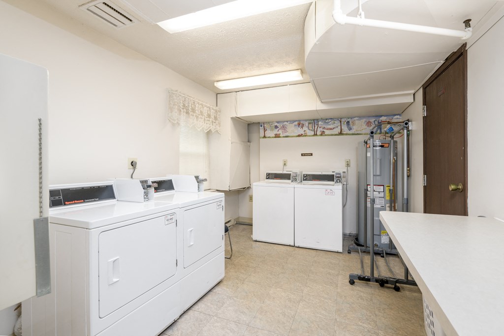 a laundry room with two washes and two dryers in it