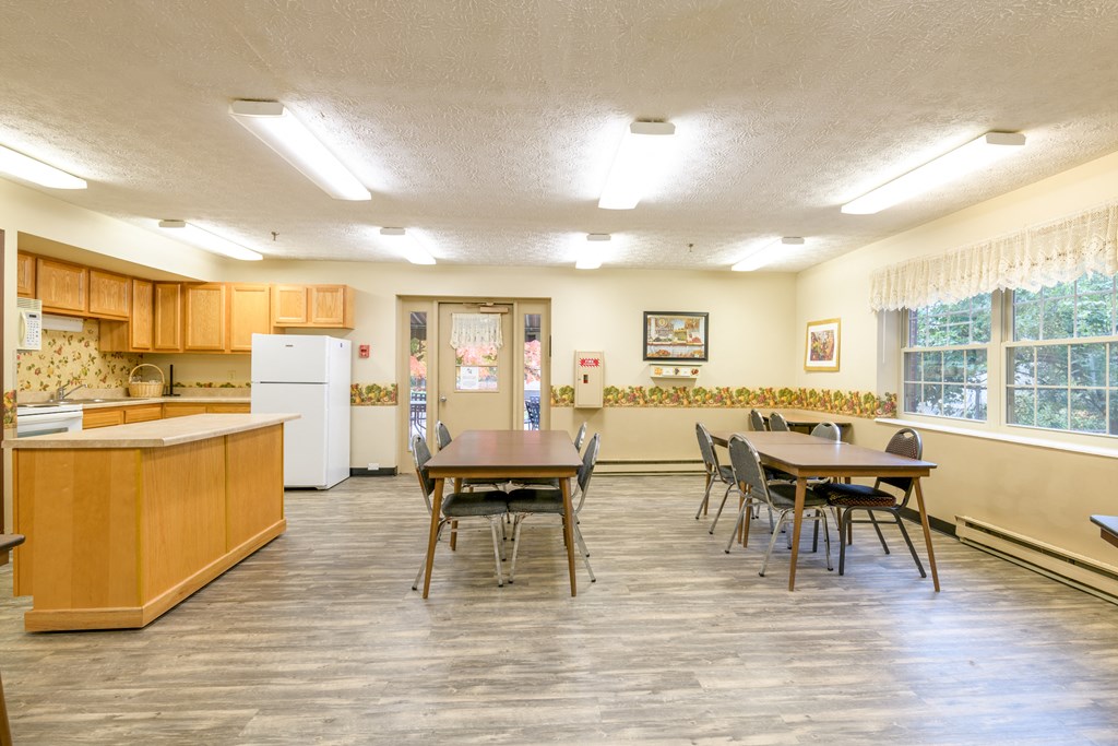 a dining room and kitchen with a table and chairs