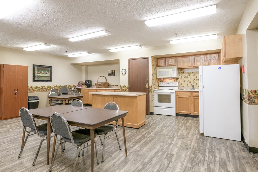 a kitchen and dining room with a table and chairs