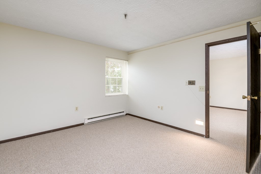 an empty room with a door and a window