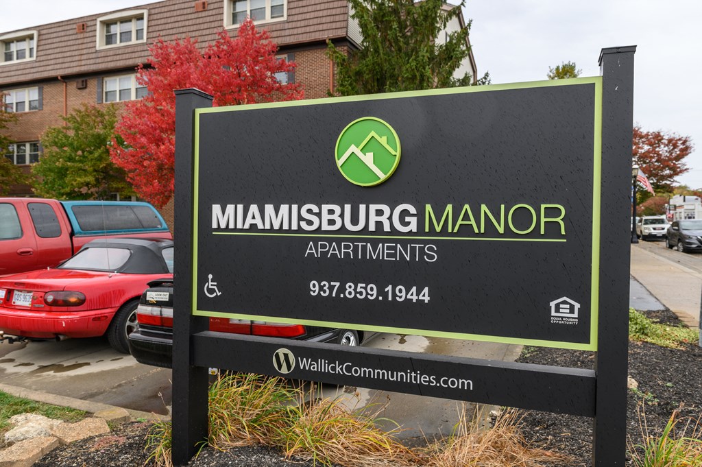 a sign that apartments in a parking lot