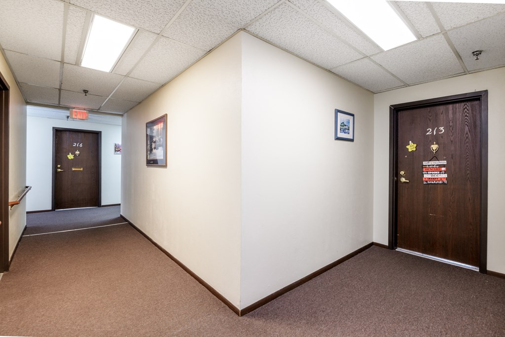 a room with two doors and a white wall