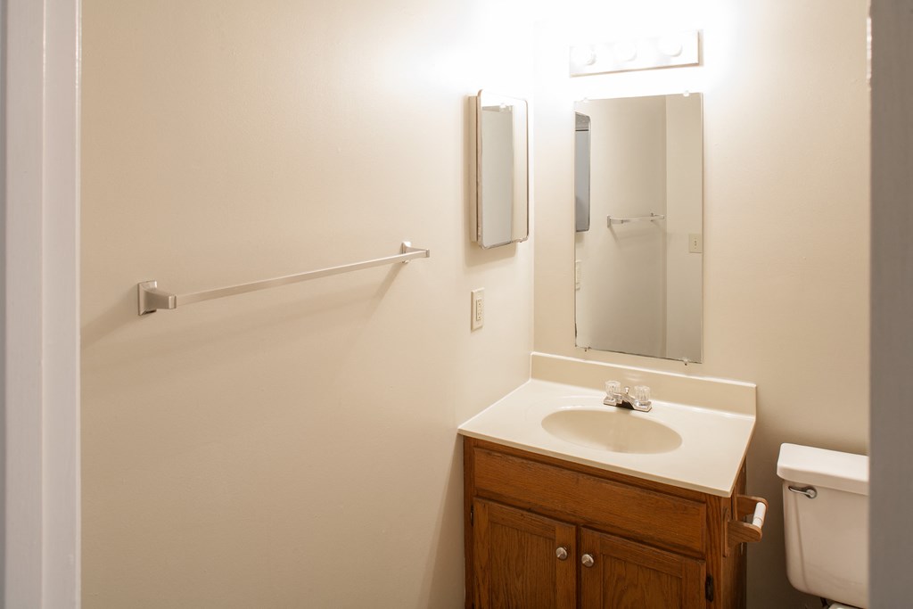 a small bathroom with a sink and a mirror