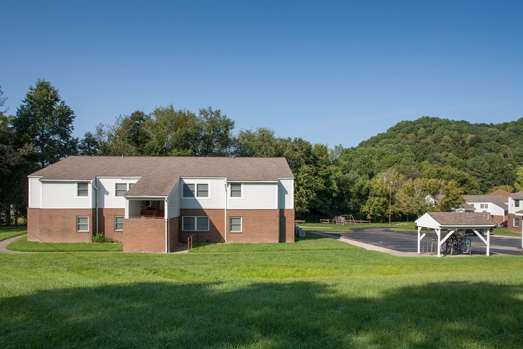 a large brick building with a picnic area in front of it