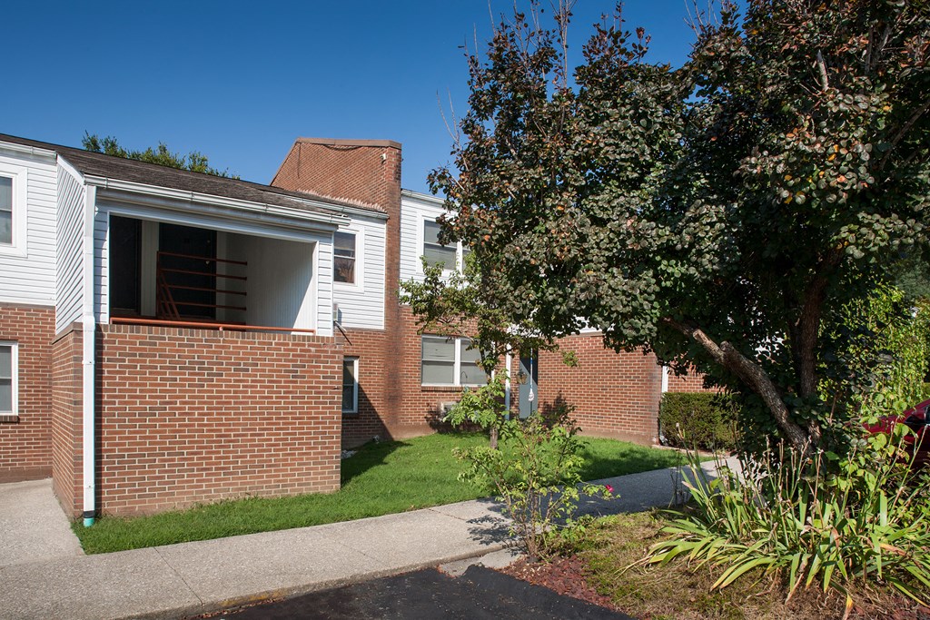 a brick building with a tree in front of it