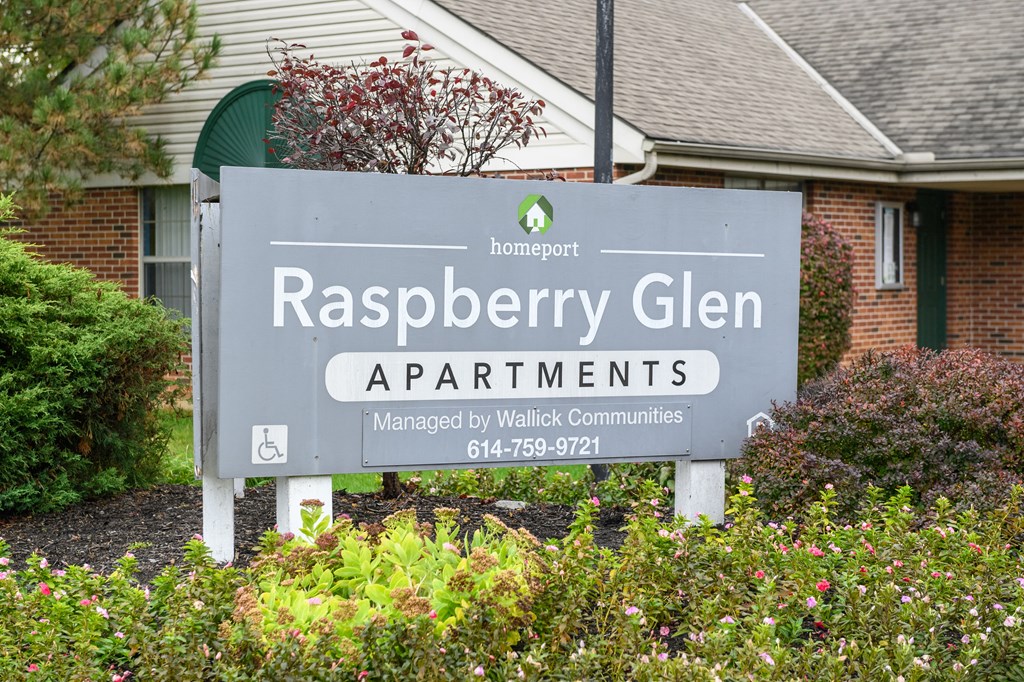 a sign apartments in front of a house