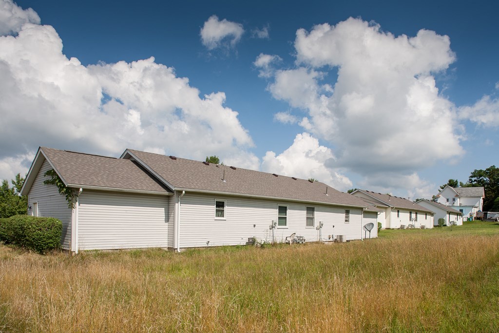 a row of white houses in a field