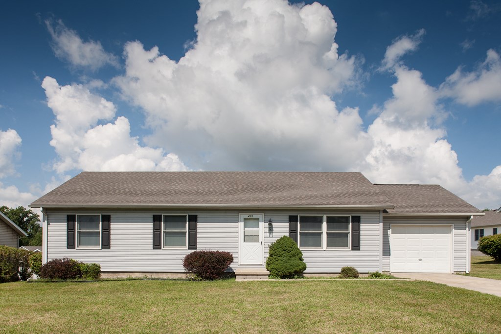 an image of a white house with a cloudy sky in the background