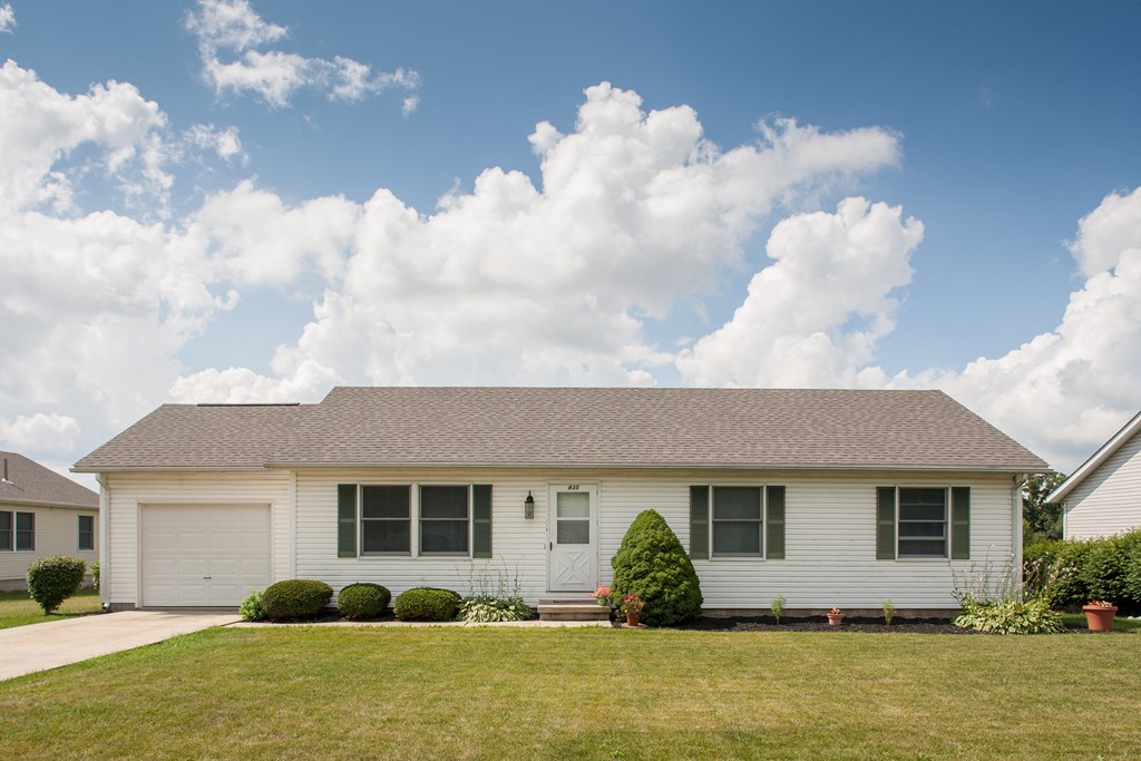 a white house with a lawn in front of it