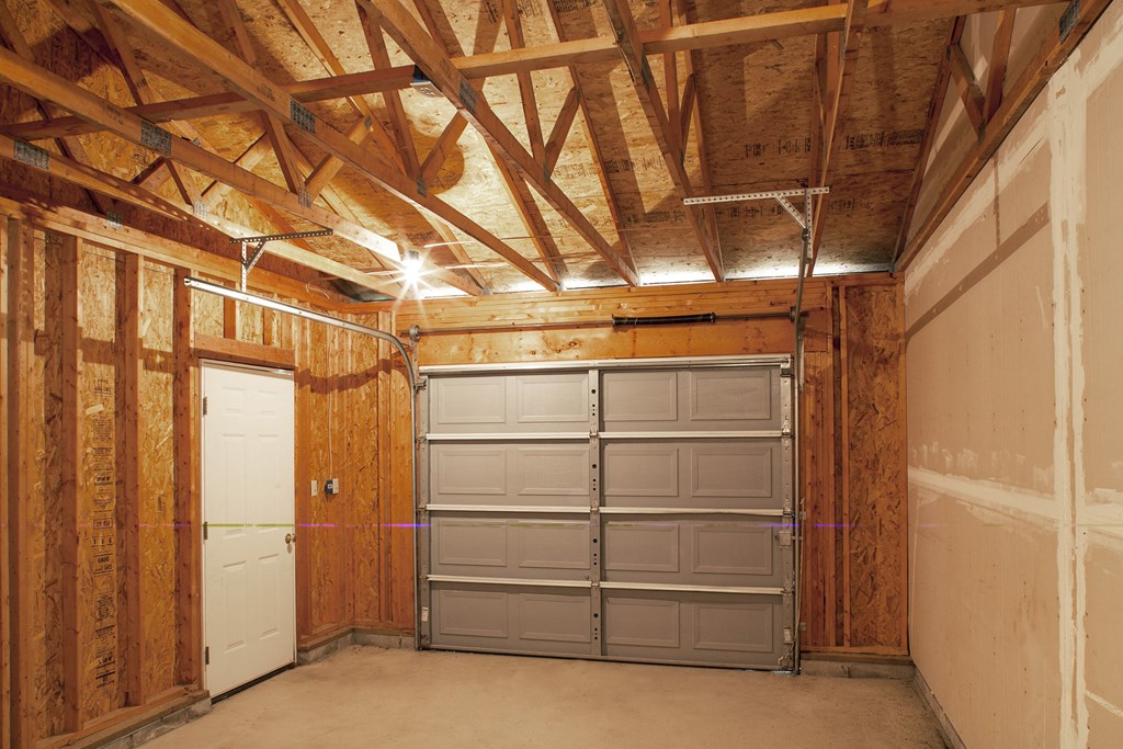 a garage with a door and a white door