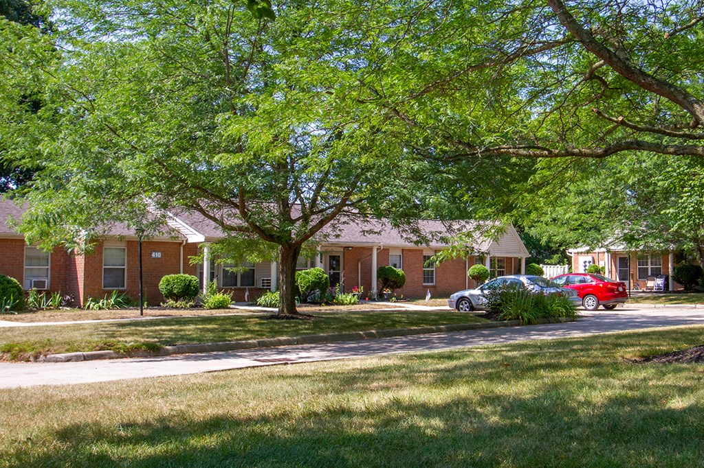 a house with a red car parked in front of it