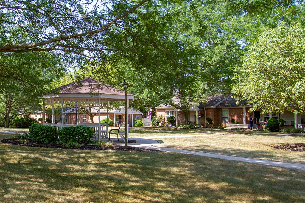 a park with a gazebo in front of some houses