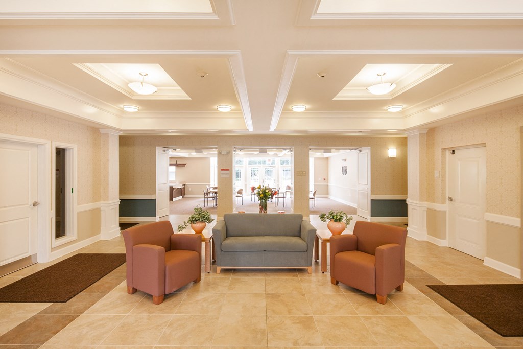 a lobby of a hospital with couches and chairs