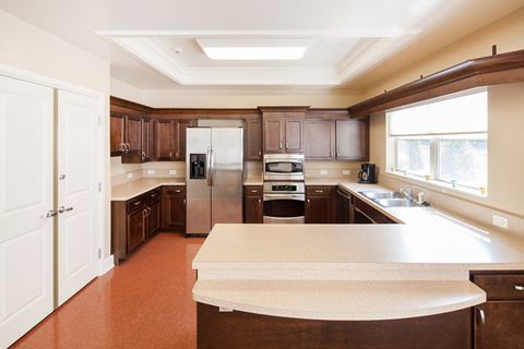a kitchen with wooden cabinets and a white counter top