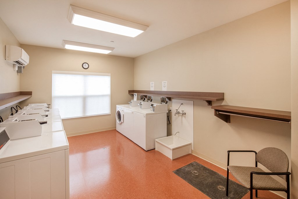 a laundry room with washing machines and a window
