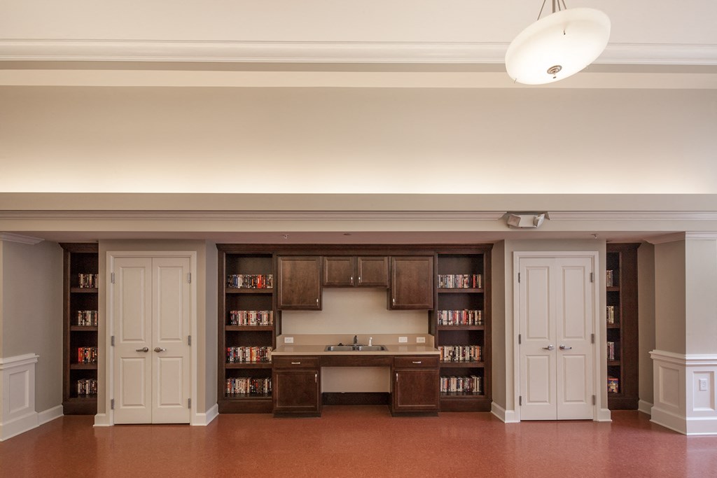 a kitchen with white cabinets and a counter with a sink