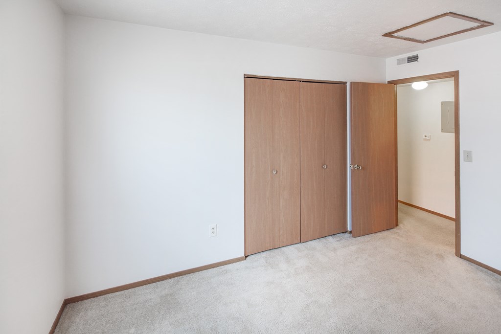 a living room with two doors and a white wall
