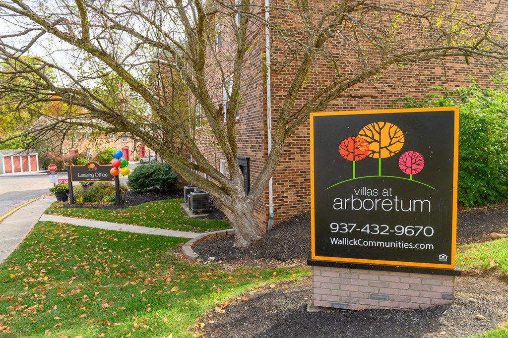 a sign for the walks in front of a brick building