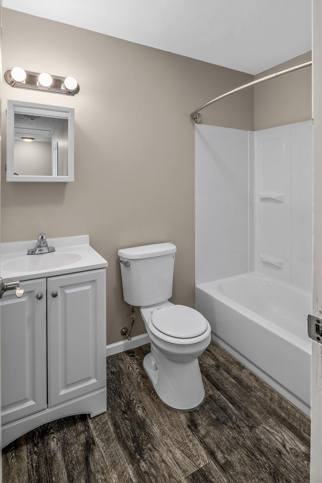 a bathroom with a toilet and a tub and a sink