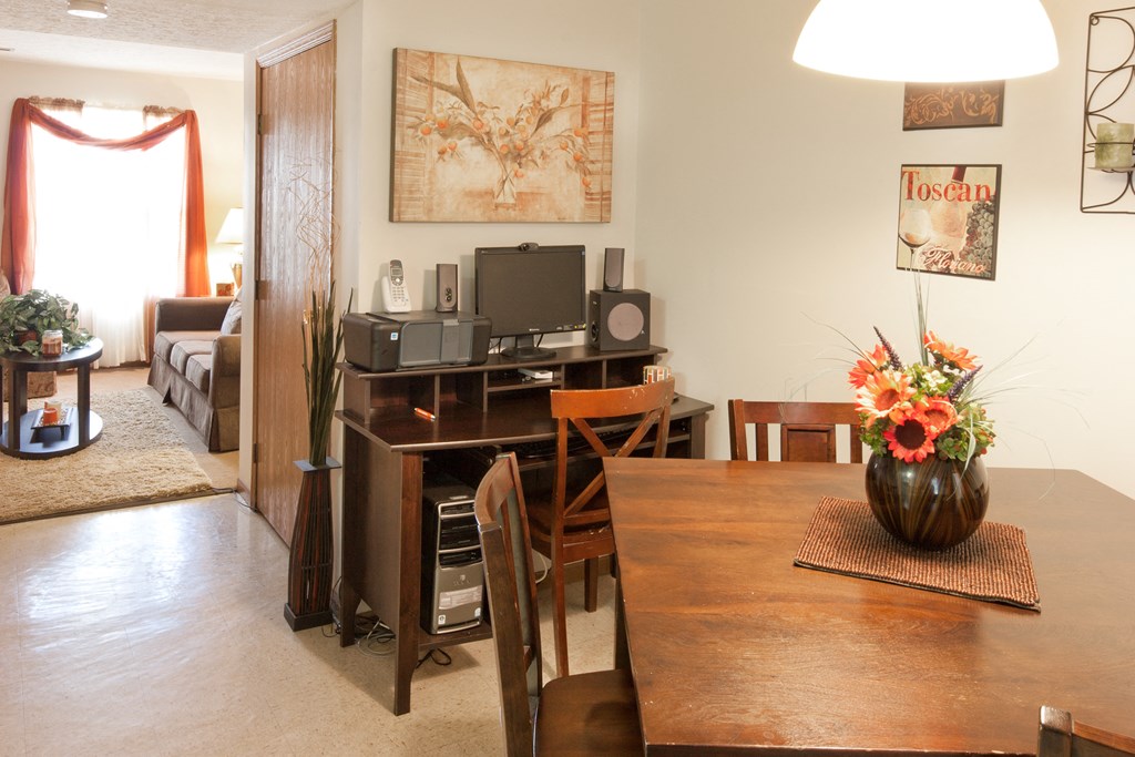 a dining room table with a vase of flowers on top of it