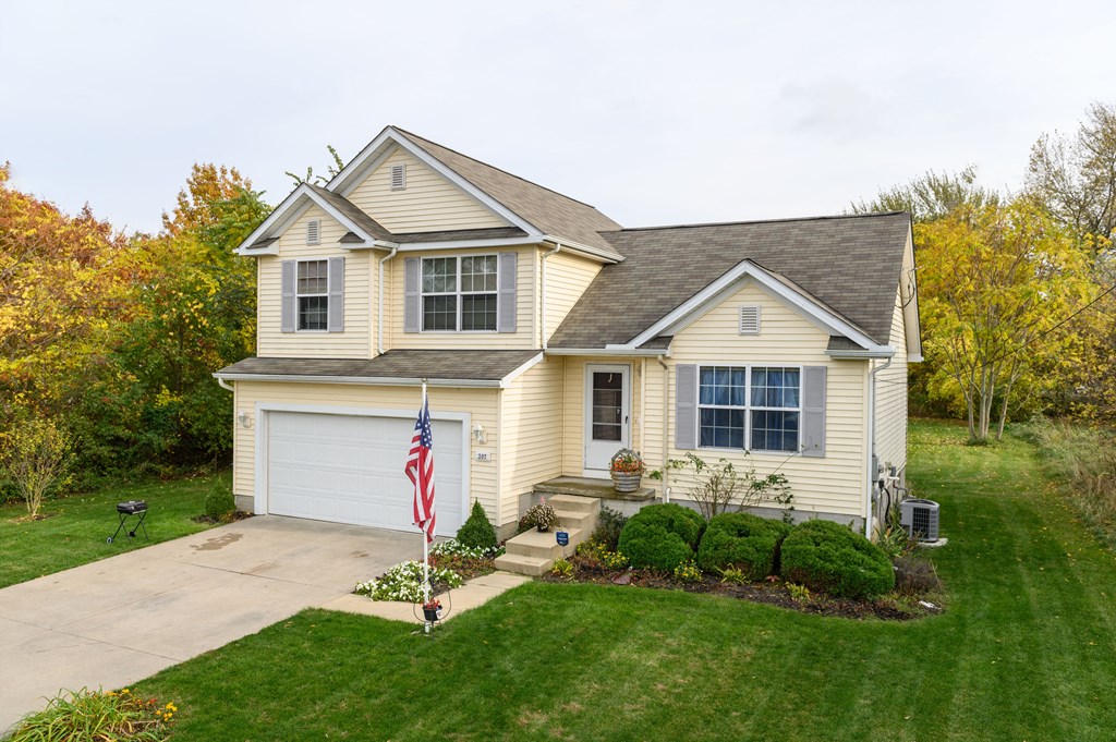 a home with an flag on the driveway