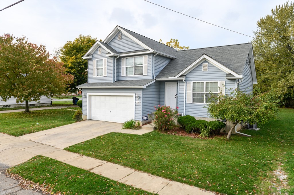 a blue house with a white garage door