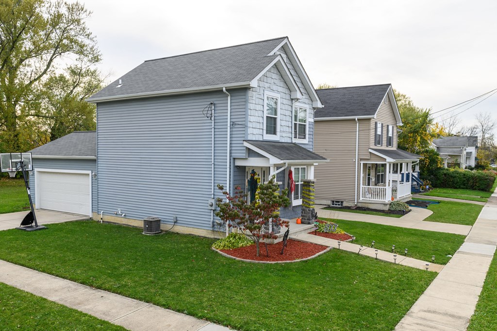 a blue house with a garden in front of it