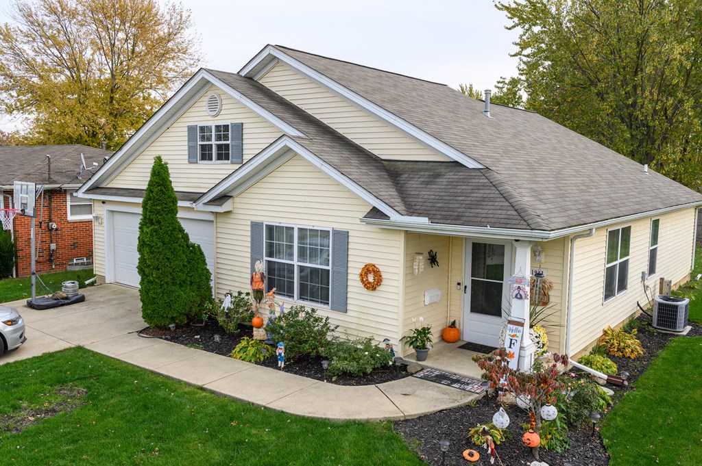 a home decorated for halloween with pumpkins on the front yard