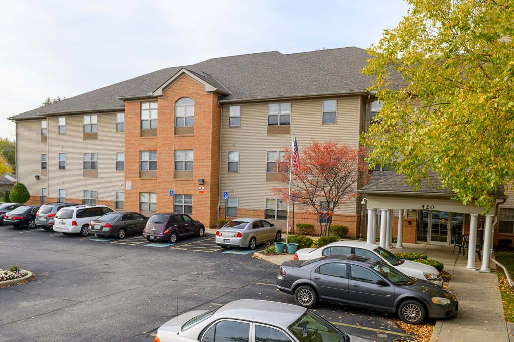 an apartment building with cars parked in front of it