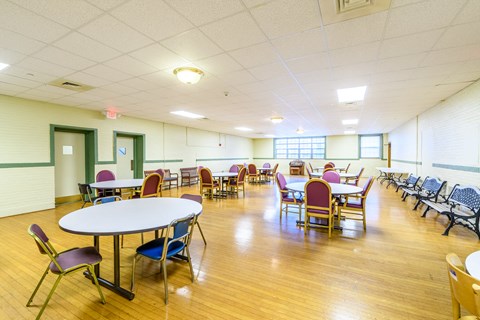 a dining room with tables and chairs and a wood floor