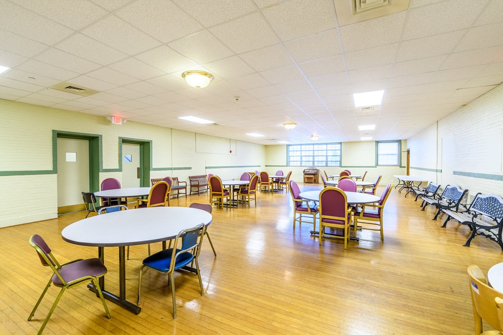 a dining room with tables and chairs and a wood floor