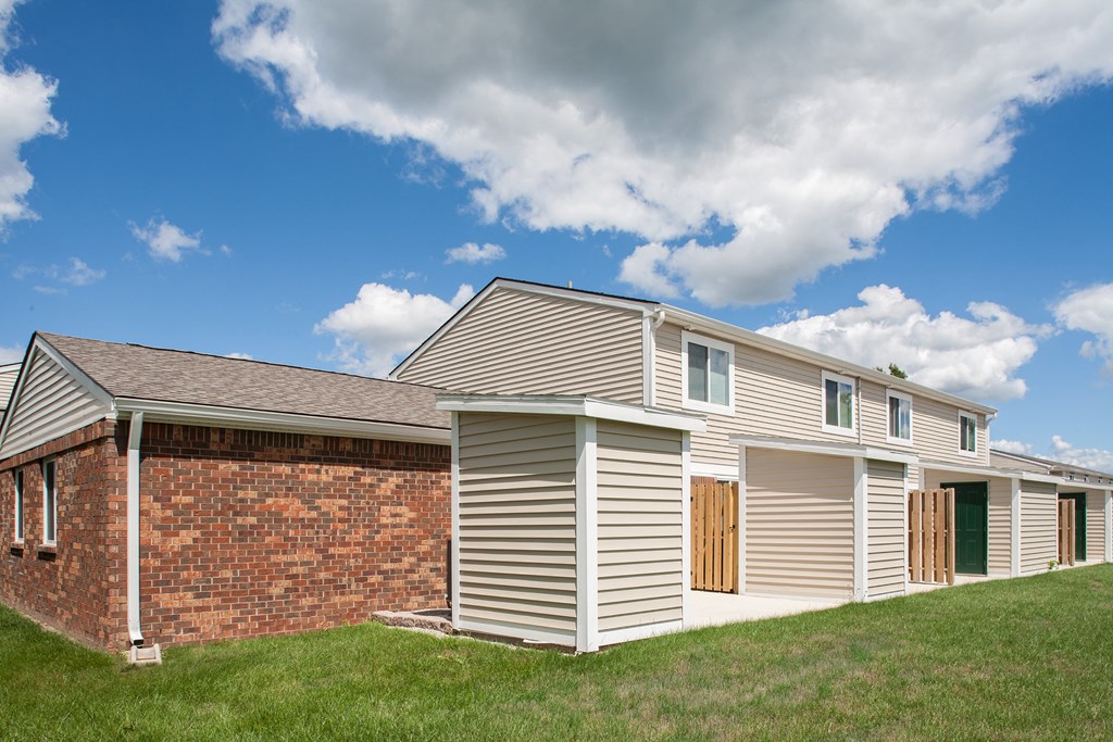 a house with a garage and a brick wall