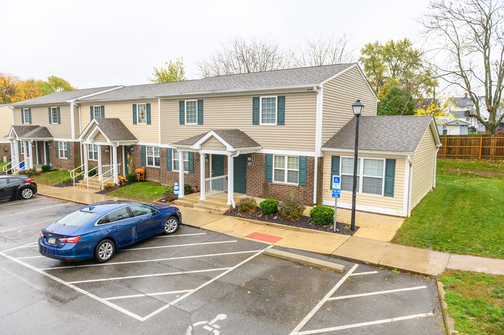 a car parked in a parking lot in front of a house