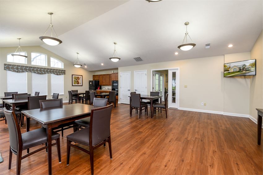 a dining room with a table and chairs and a kitchen