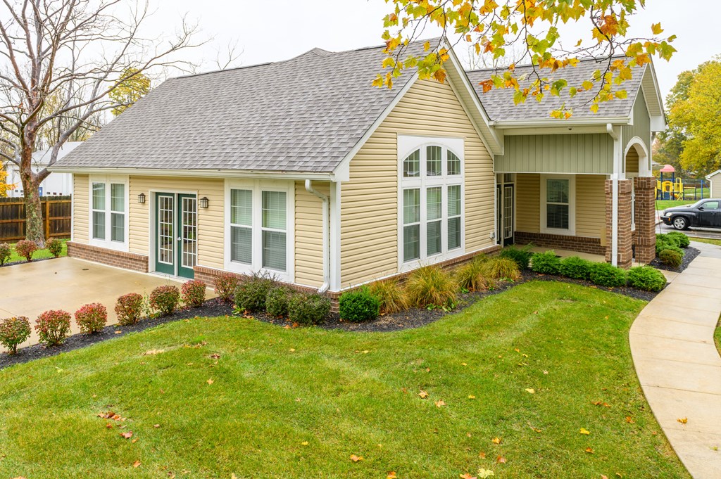 the front of a house with a yard and a driveway