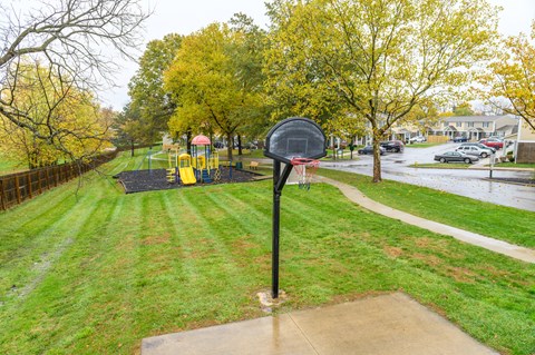 a mailbox in the middle of a park with a playground