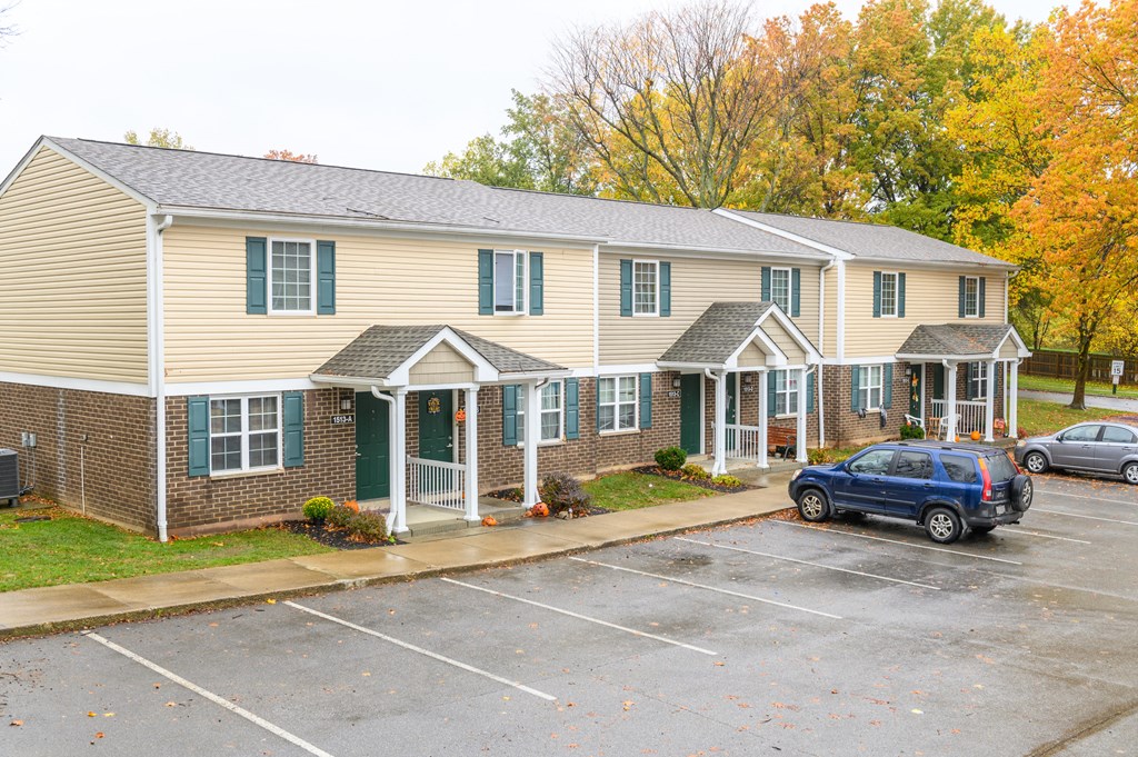 a car parked in a parking lot in front of a house