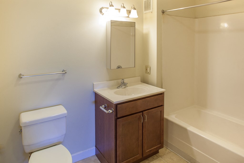 a bathroom with a sink toilet and a bath tub