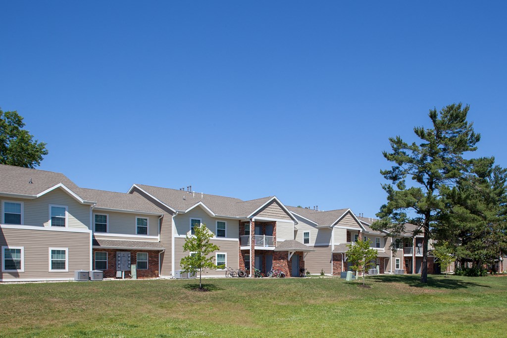 a row of houses on a hill with a blue sky