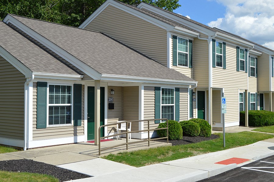 the exterior of a building with a ramp and a porch