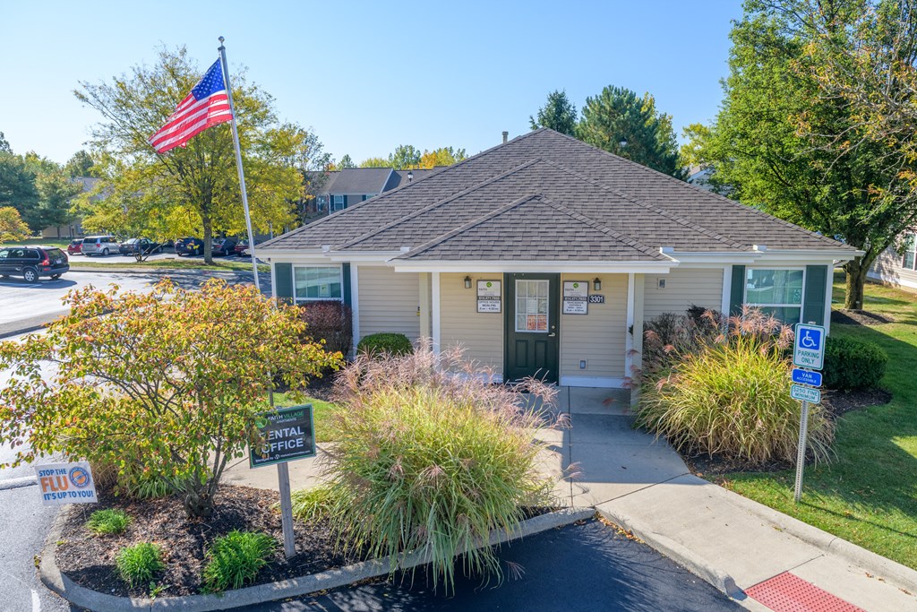 a small white building with an flag in front of it