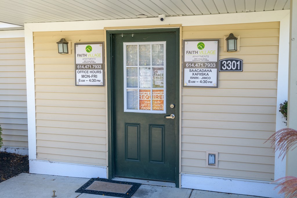 the front door of a house with signs on the side of it