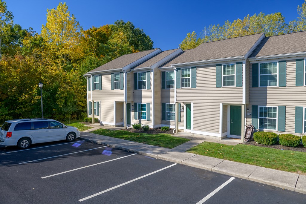 an apartment building with a car parked in front of it