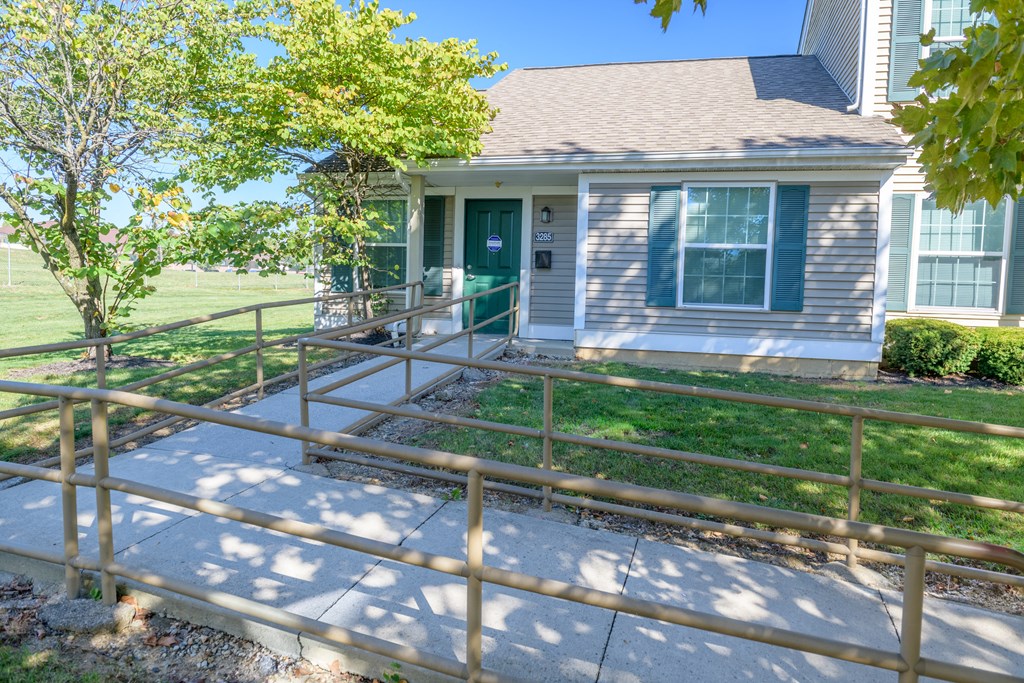 the front porch of a house with a ramp to the front door