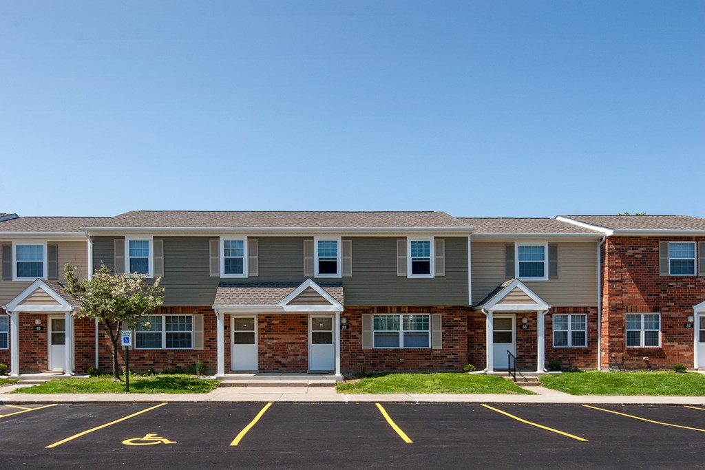 a large apartment building with a street in front of it
