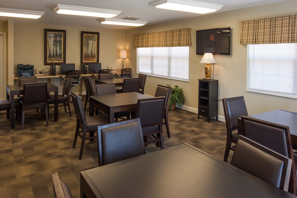 a dining room with tables and chairs and a television