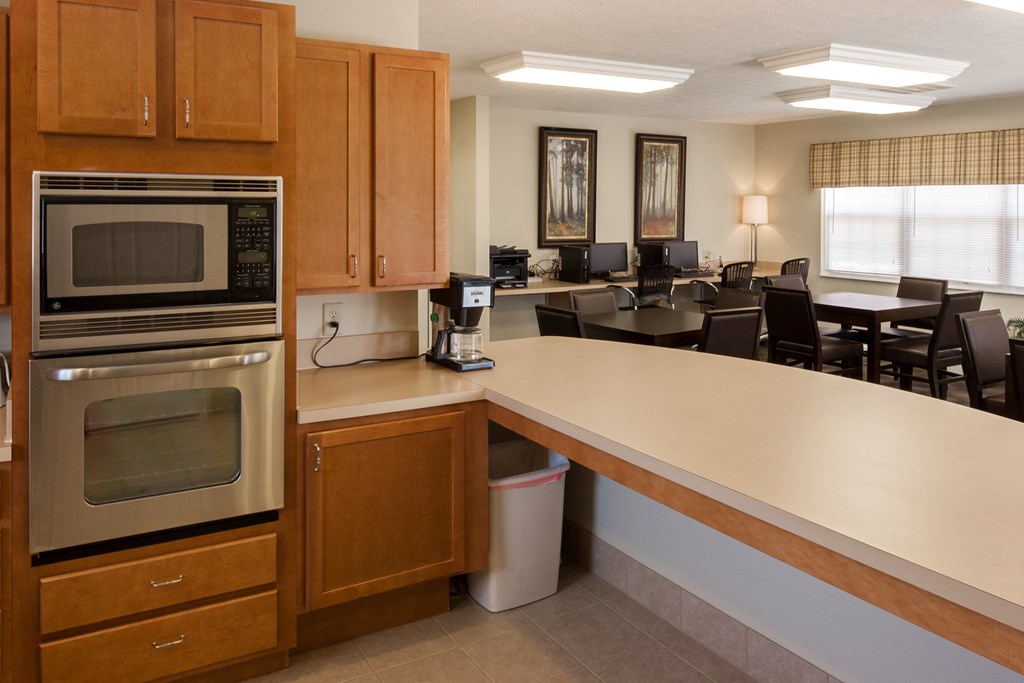 a kitchen and dining room area in a hotel room