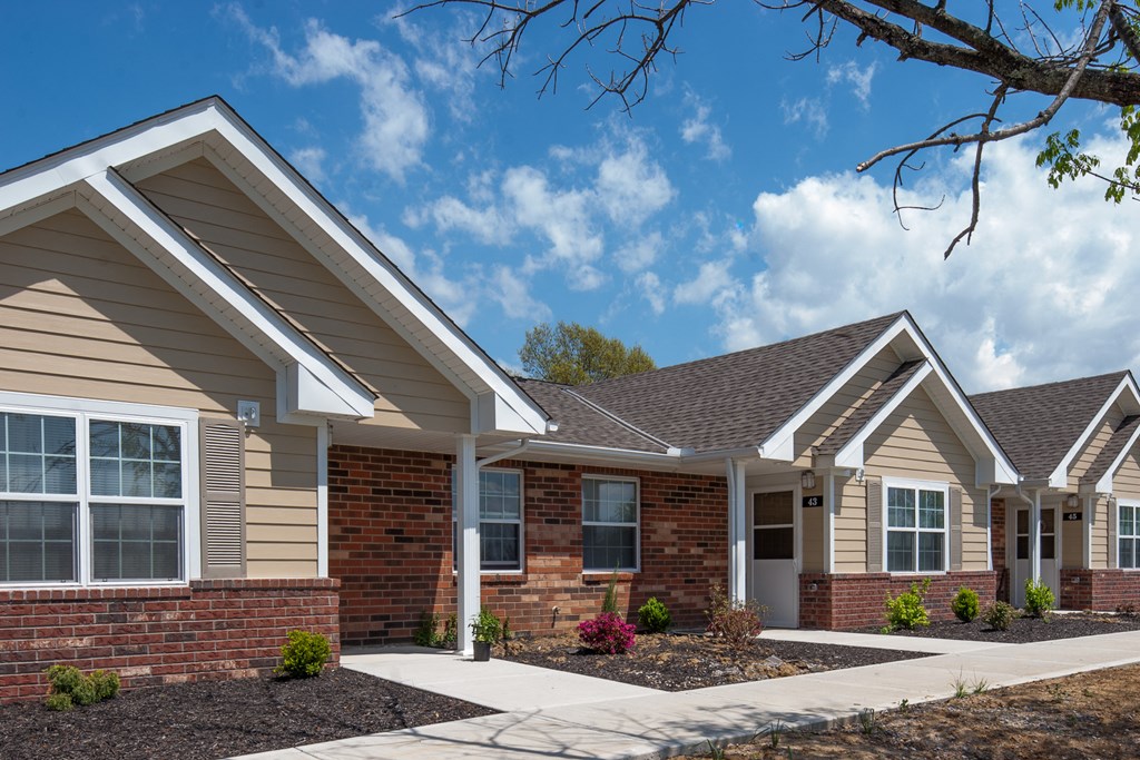 a brick building with a sidewalk in front of it