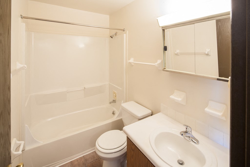 a bathroom with a sink toilet and bath tub